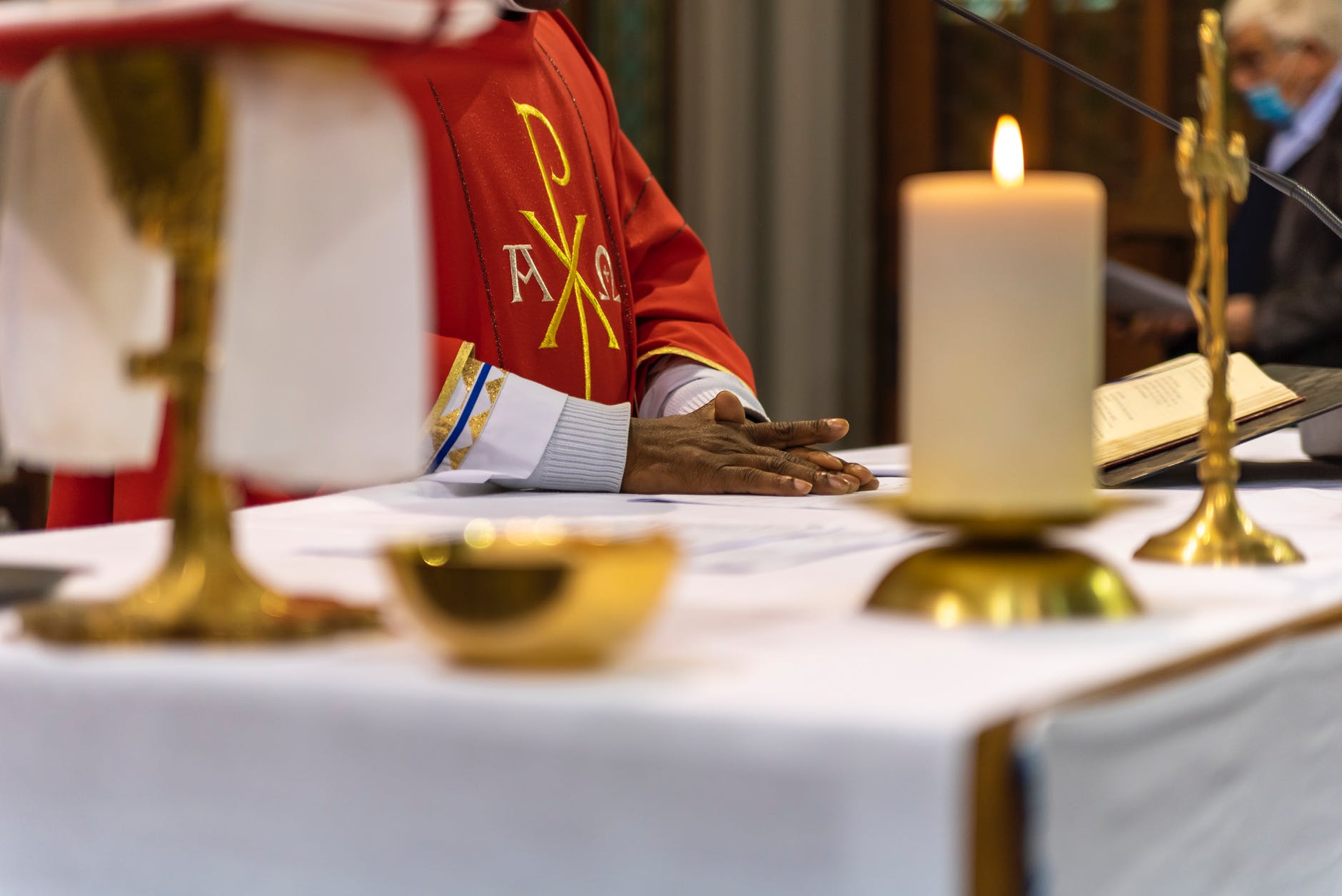 priest hand on altar